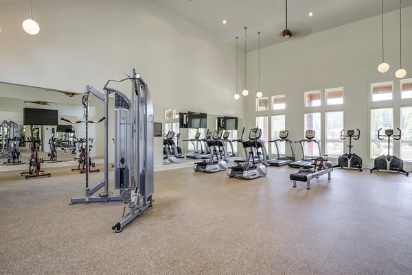 Modern fitness center with state-of-the-art equipment at Grand Oaks at Crane Creek Apartments offering active lifestyle amenities