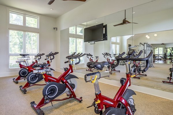State-of-the-art spin studio at Grand Oaks at Crane Creek Apartments with modern equipment and vibrant workout atmosphere