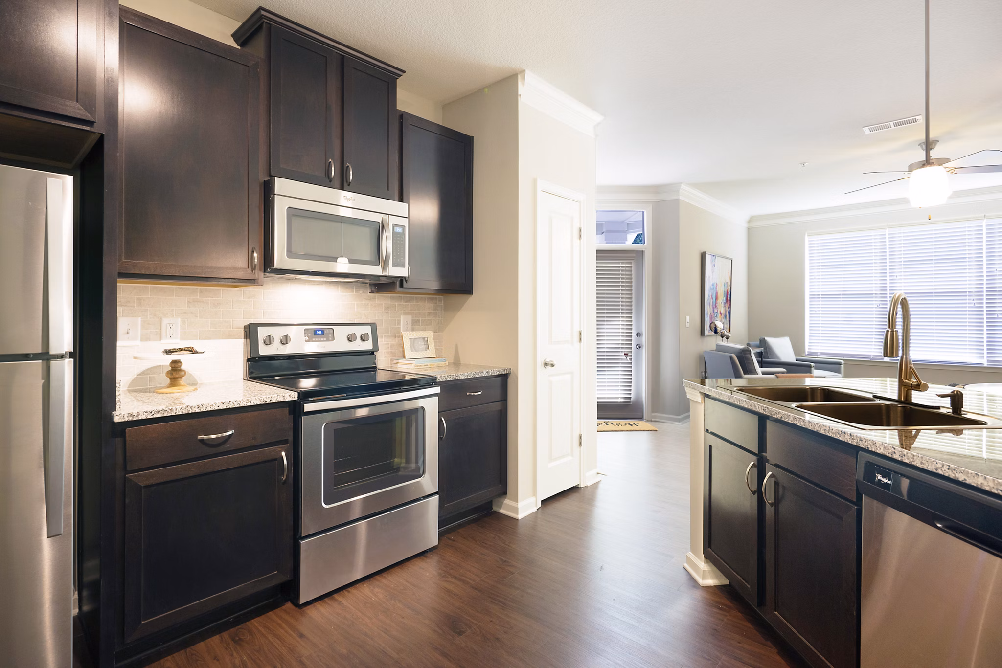 Modern kitchen with sleek cabinetry and stainless steel appliances at Grand Oaks at Crane Creek Apartments