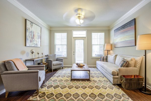 Cozy living room with modern furnishings in Grand Oaks at Crane Creek Apartments