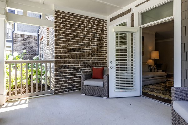 Patio with stylish outdoor furniture at Grand Oaks at Crane Creek Apartments, perfect for relaxing and enjoying sunny weather