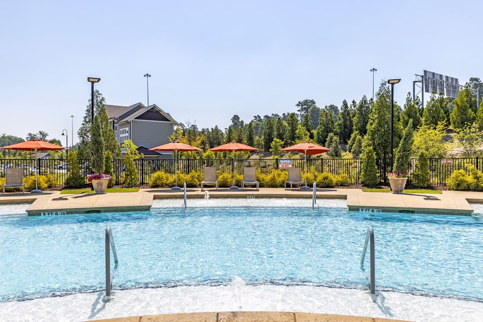 Inviting outdoor pool at Grand Oaks at Crane Creek Apartments offering relaxation and leisure for residents