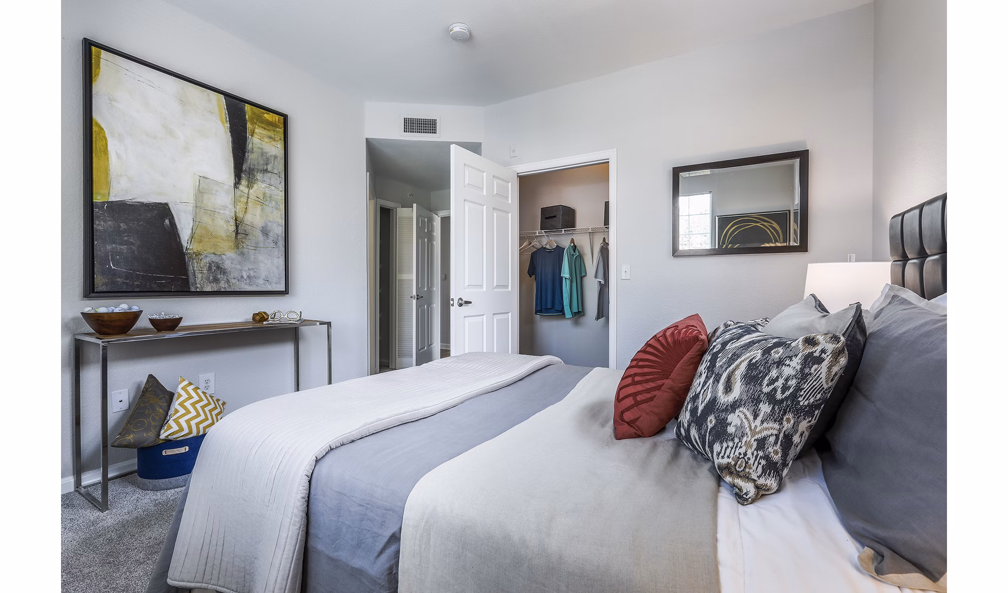 Bedroom with modern decor and large windows at Avana Eastlake Apartments
