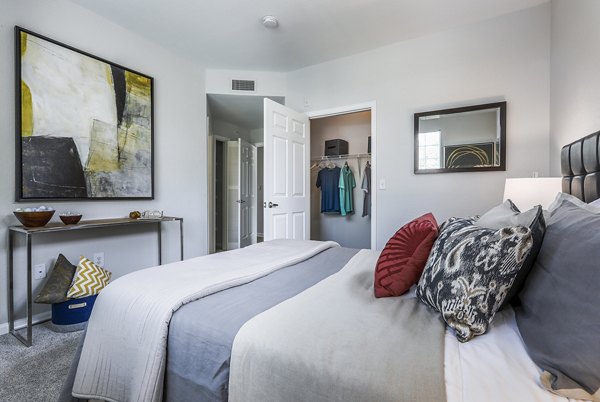 Bedroom with modern decor and large windows at Avana Eastlake Apartments