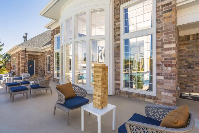 Scenic patio area featuring modern seating and lush greenery at Avana Eastlake Apartments