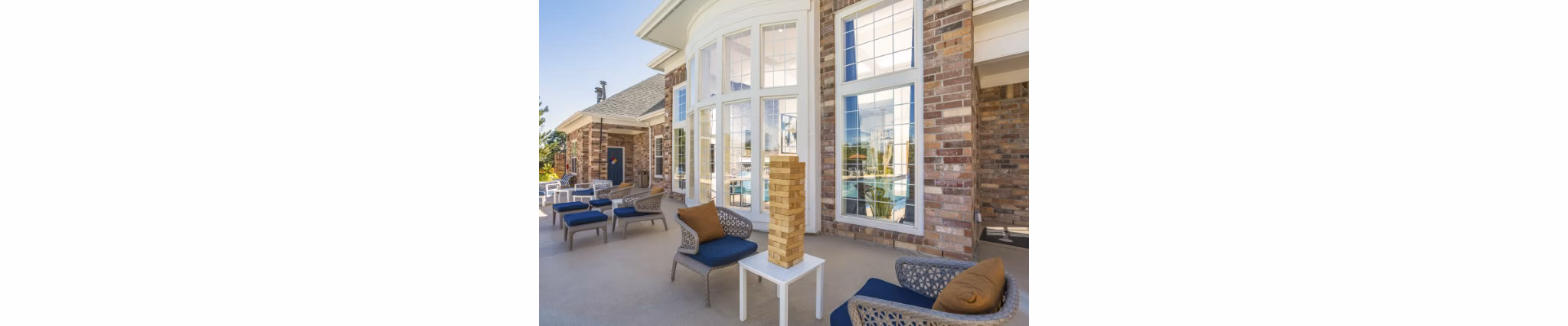 Scenic patio area featuring modern seating and lush greenery at Avana Eastlake Apartments