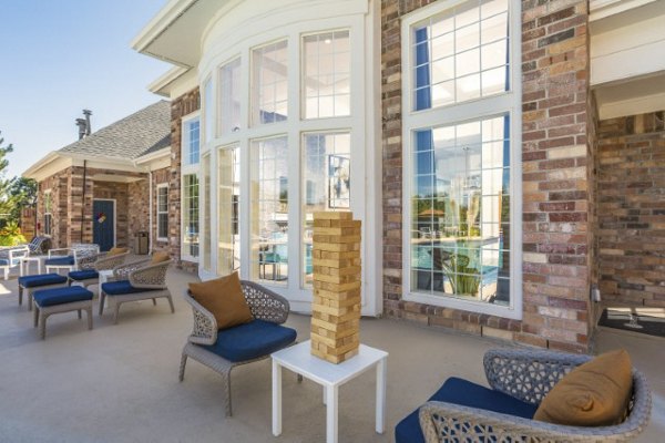 Scenic patio area featuring modern seating and lush greenery at Avana Eastlake Apartments