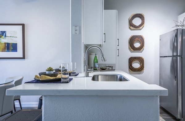 Dining room with modern furnishings and pendant lighting at Avana Eastlake Apartments, a luxury Greystar property in vibrant Eastlake area