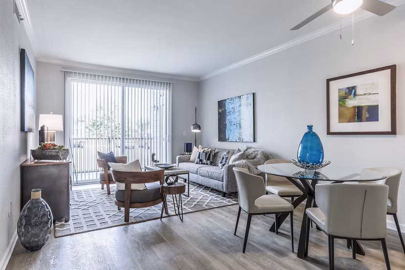 Dining room with modern furnishings at Avana Eastlake Apartments featuring elegant lighting and large windows