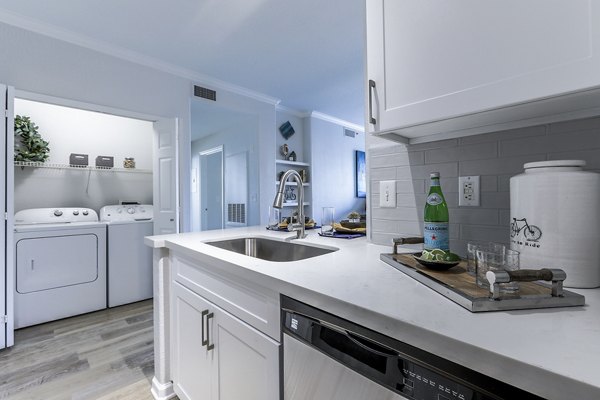 Kitchen featuring modern appliances and sleek cabinetry at Avana Eastlake Apartments
