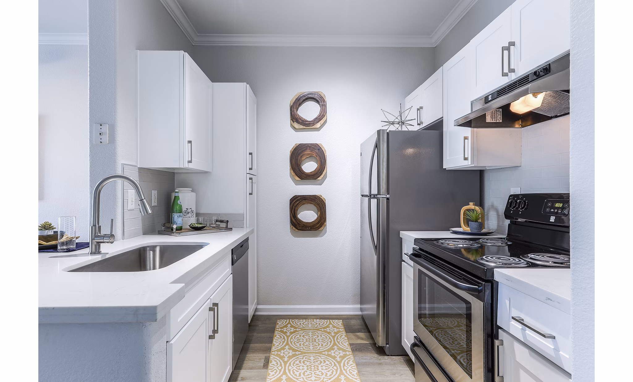 Modern kitchen with stainless steel appliances and granite countertops at Avana Eastlake Apartments