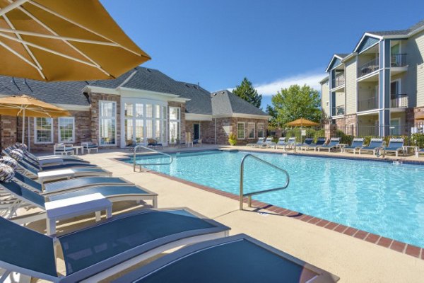 Poolside relaxation area at Avana Eastlake Apartments with lounge chairs and landscaped views