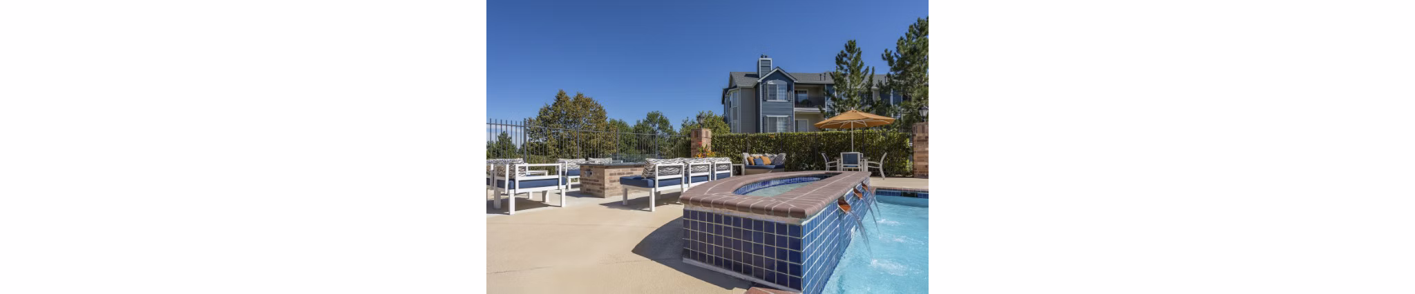 Cozy fire pit seating area at Avana Eastlake Apartments with surrounding lush greenery