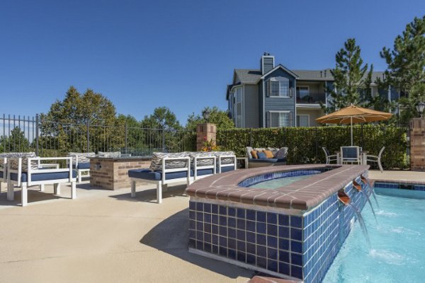 Cozy fire pit seating area at Avana Eastlake Apartments with surrounding lush greenery