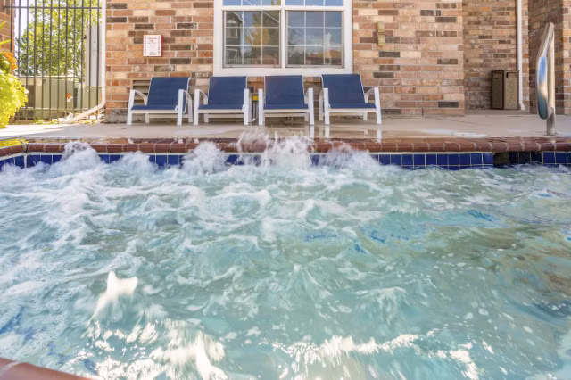 Hot tub with serene garden view at Avana Eastlake Apartments offering luxury relaxation experiences