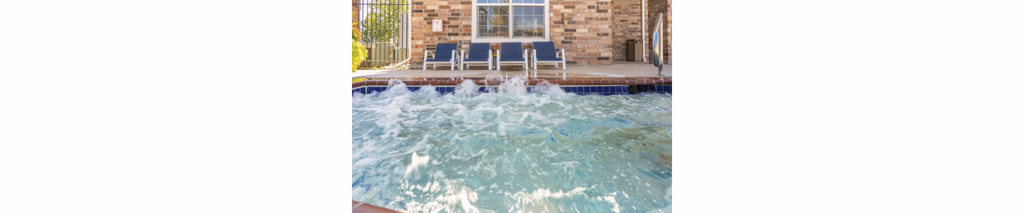 Hot tub with serene garden view at Avana Eastlake Apartments offering luxury relaxation experiences