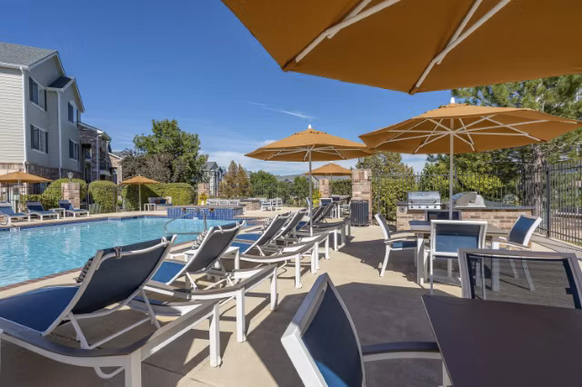 Relaxing pool area with sun loungers at Avana Eastlake Apartments, a premier Greystar community