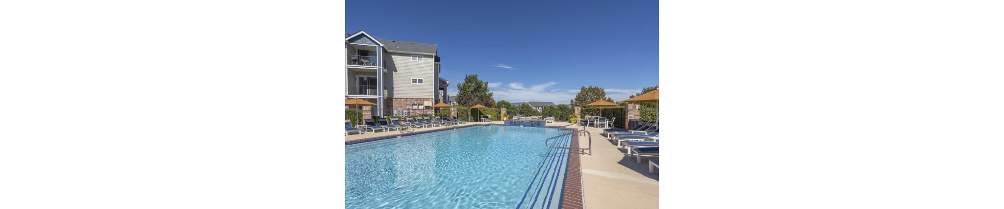 Resort-style pool with lounge chairs at Avana Eastlake Apartments