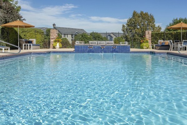 Poolside luxury at Avana Eastlake Apartments: Relax by the modern outdoor pool with comfortable lounge seating