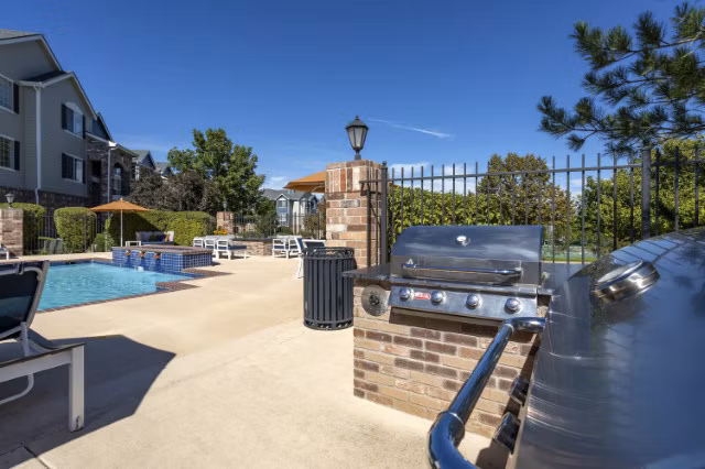 Outdoor grill area with modern seating at Avana Eastlake Apartments, perfect for hosting gatherings or enjoying a BBQ with friends