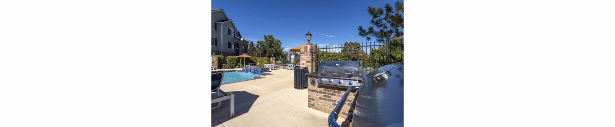 Outdoor grill area with modern seating at Avana Eastlake Apartments, perfect for hosting gatherings or enjoying a BBQ with friends