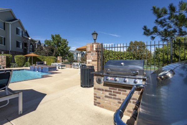 Outdoor grill area with modern seating at Avana Eastlake Apartments, perfect for hosting gatherings or enjoying a BBQ with friends