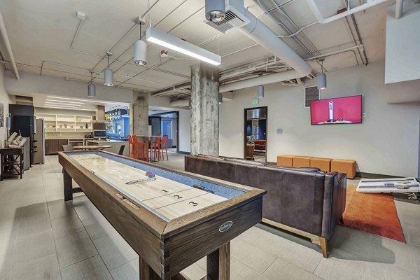 Game room featuring pool table and lounge seating at Cooper George Apartments in Seattle