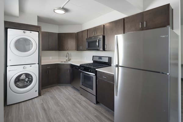 Modern kitchen with stainless steel appliances and sleek countertops at Cooper George Apartments