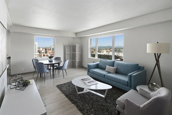 Cooper George Apartments: Elegant living room with contemporary furniture and large windows in luxury apartment community