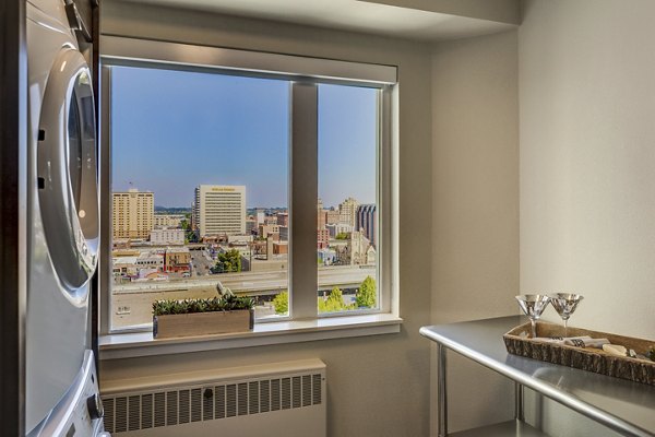 Laundry room featuring modern washers and dryers in Cooper George Apartments