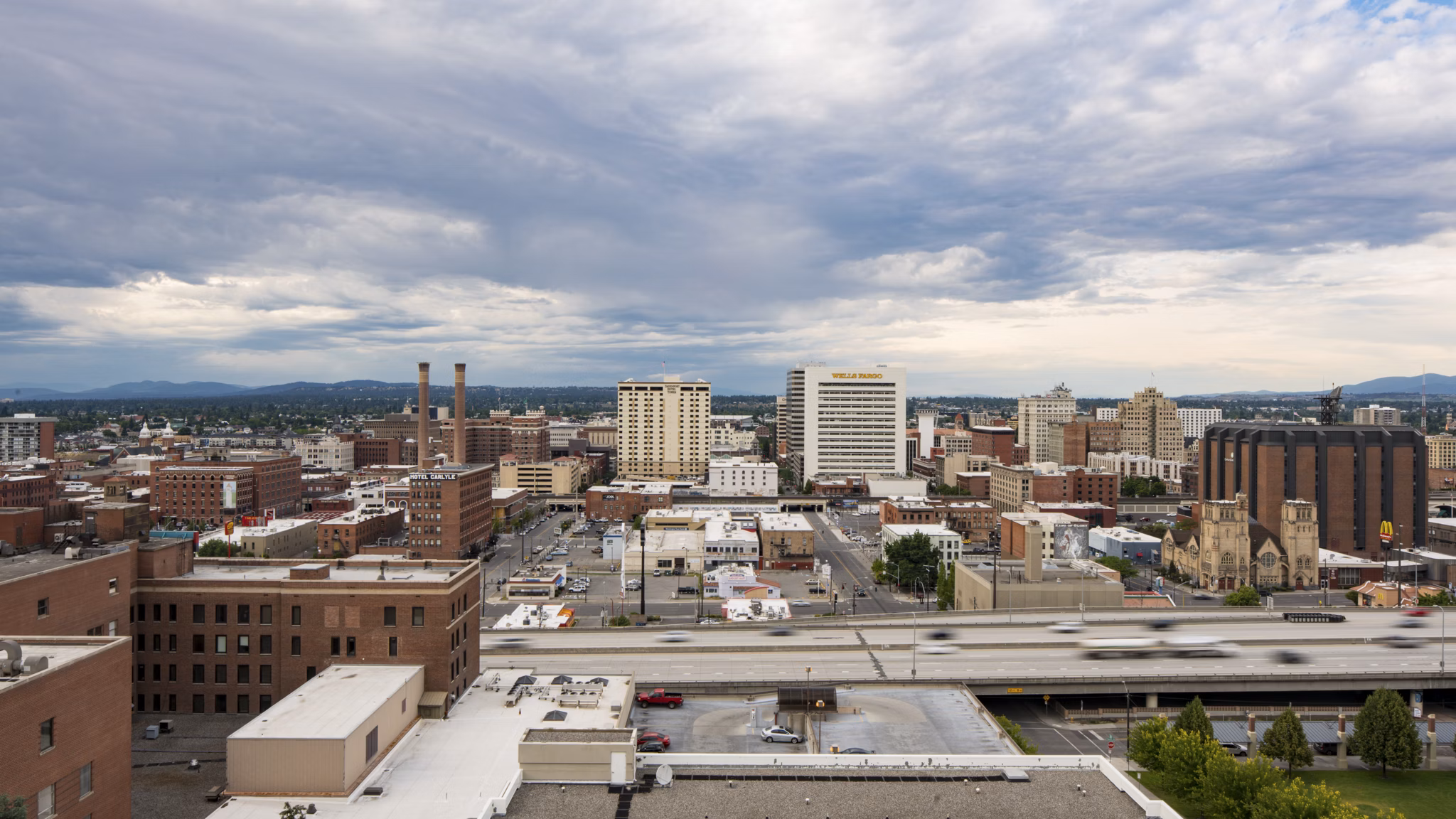 Cooper George Apartments: Stunning cityscape view from luxury apartment balcony in vibrant downtown setting