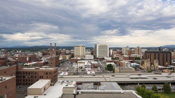 Cooper George Apartments: Stunning cityscape view from luxury apartment balcony in vibrant downtown setting
