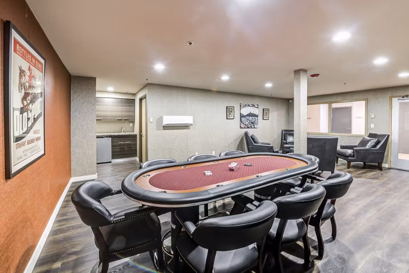 Modern clubhouse with cozy seating and billiards at Avana on Pine Apartments