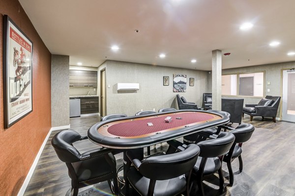Modern clubhouse with cozy seating and billiards at Avana on Pine Apartments