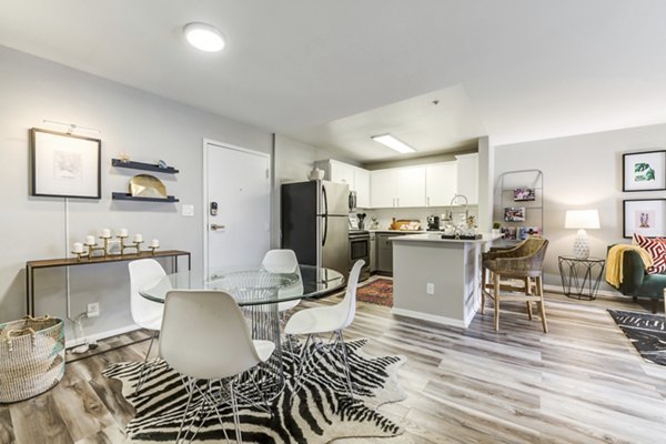 Dining area with elegant furnishings and modern lighting at Avana on Pine Apartments