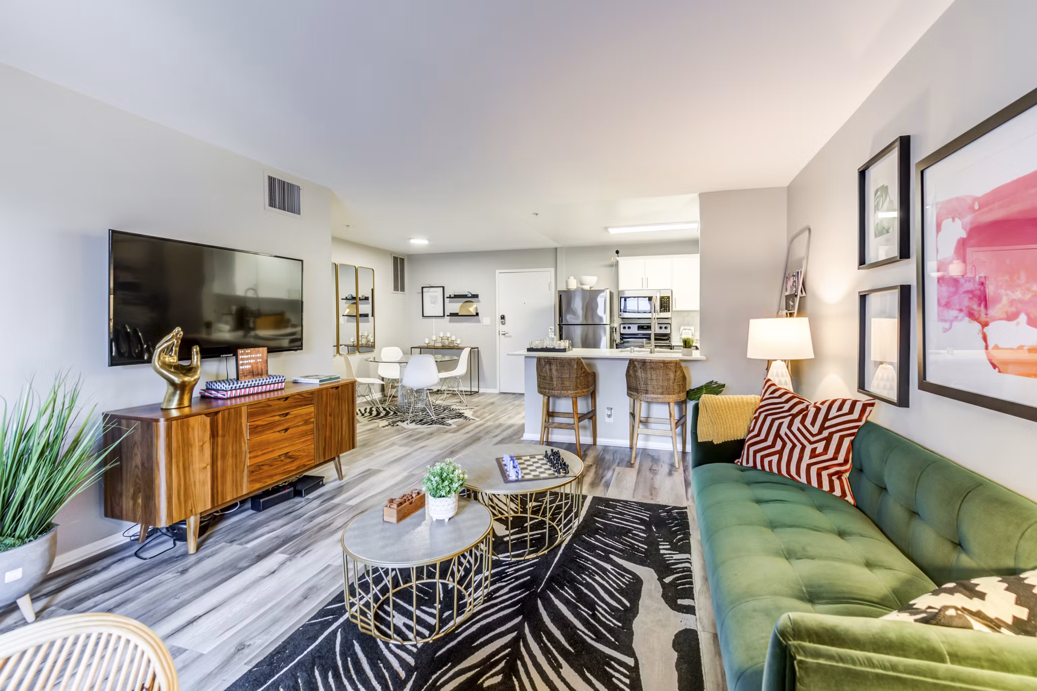 Elegant living room with plush seating and large windows at Avana on Pine Apartments