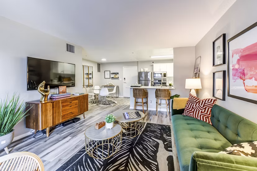 Elegant living room with plush seating and large windows at Avana on Pine Apartments