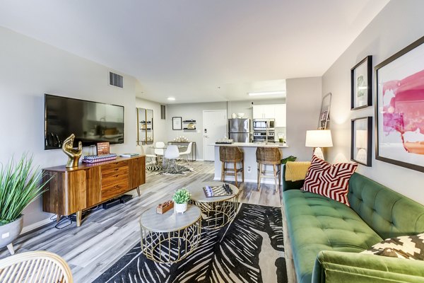 Elegant living room with plush seating and large windows at Avana on Pine Apartments