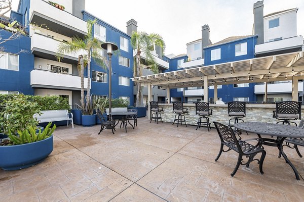 Beautifully landscaped courtyard featuring seating and gardens at Avana on Pine Apartments