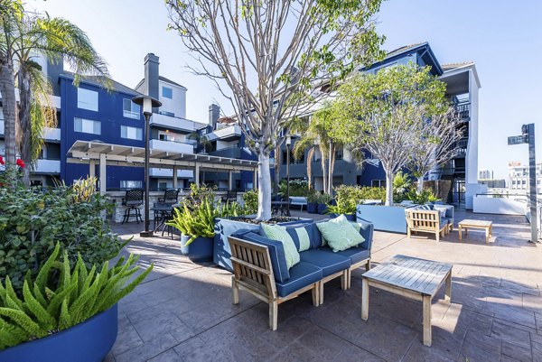 Courtyard with lush greenery and seating at Avana on Pine Apartments, offering serene outdoor living spaces