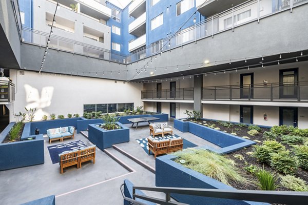 Serene courtyard with lush greenery at Avana on Pine Apartments