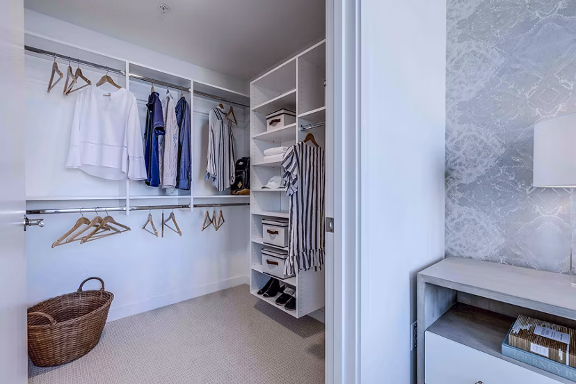 Walk-in closet with ample shelving in Ascent South Lake Union Apartments, a luxury apartment by Greystar in South Lake Union