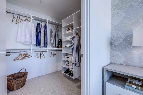 Walk-in closet with ample shelving in Ascent South Lake Union Apartments, a luxury apartment by Greystar in South Lake Union