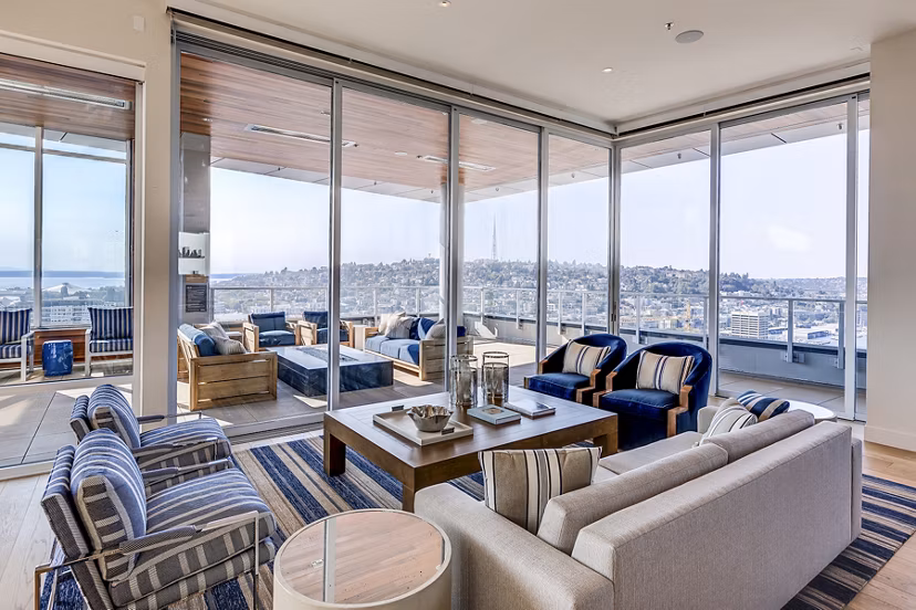 Modern clubhouse with stylish seating and fireplace at Ascent South Lake Union Apartments