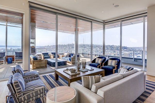 Modern clubhouse with stylish seating and fireplace at Ascent South Lake Union Apartments