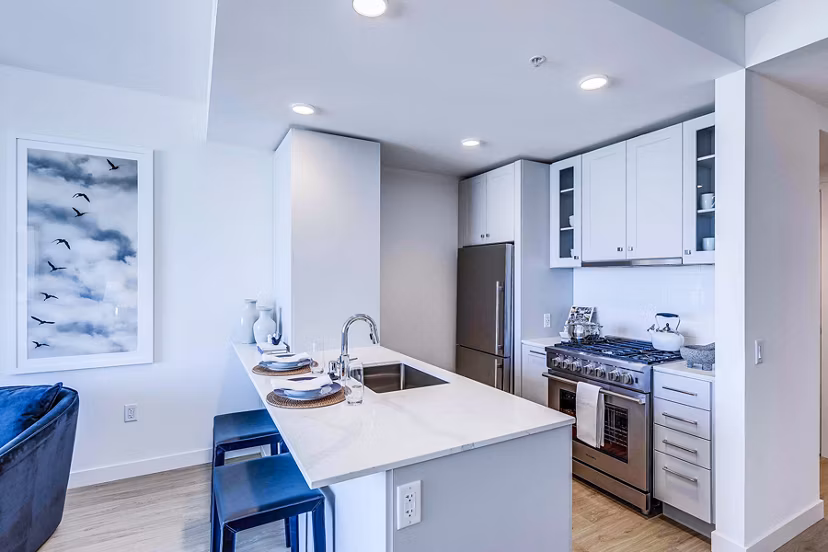Kitchens with marble countertops and stainless steel appliances at Ascent South Lake Union Apartments