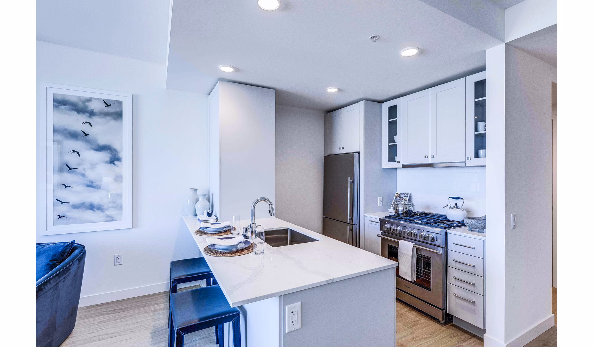 Kitchens with marble countertops and stainless steel appliances at Ascent South Lake Union Apartments