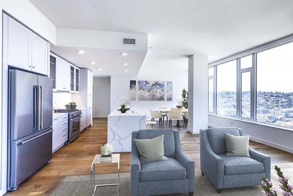 Spacious living room with modern decor and large windows at Ascent South Lake Union Apartments