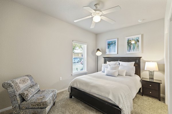 Cozy bedroom with natural light at Timberlinks at Denton Apartments, featuring luxurious decor and a serene atmosphere