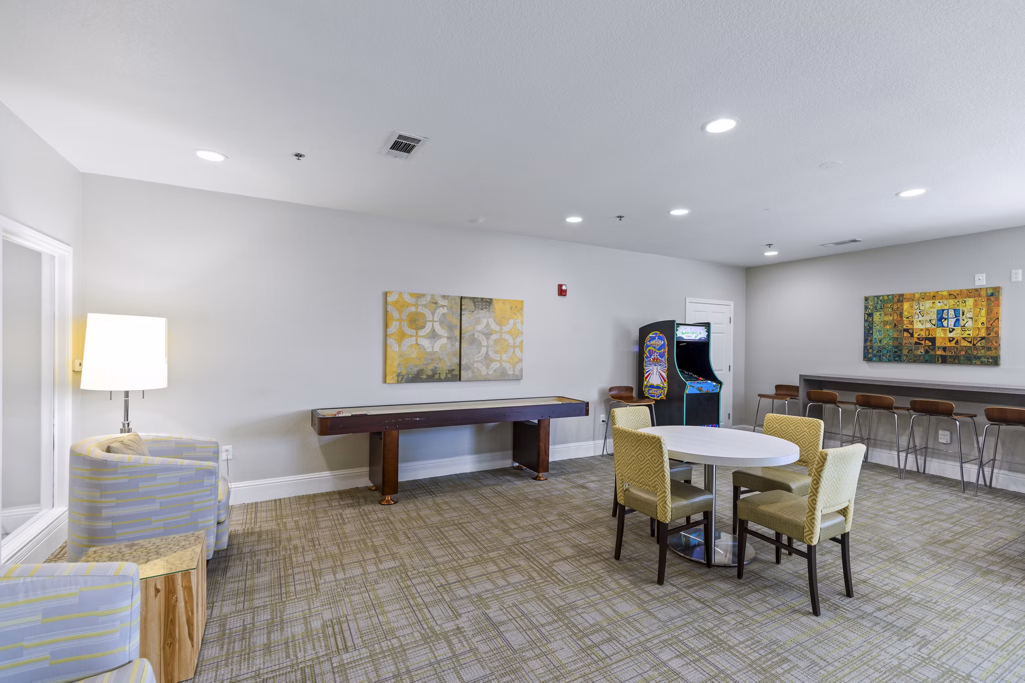 Clubhouse game room with pool table and seating at Timberlinks at Denton Apartments, ideal for resident gatherings and leisure activities